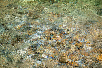 View to beautiful rainforest river pool with crystal clear green water