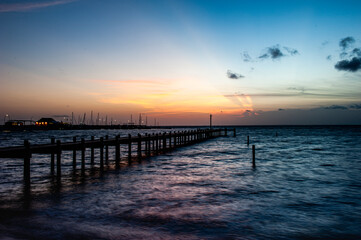Fototapeta premium Fishing pier at sunset in Fairhope , Alabama with dramatic clouds.