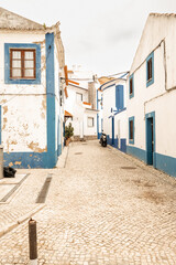 Seeing blue and white building while walking cobbled streets in