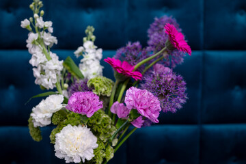 Bright floral arrangement against a vibrant blue background