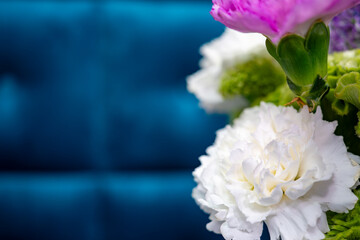 Beautiful floral arrangement with vibrant colors on blue background