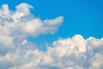 Bright blue sky with fluffy white clouds on a sunny day
