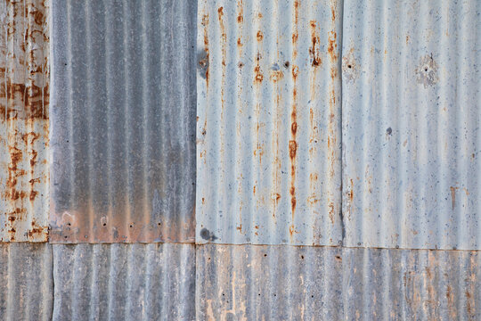 Pattern of weathered and rusty corrugated tin sheets - surface background