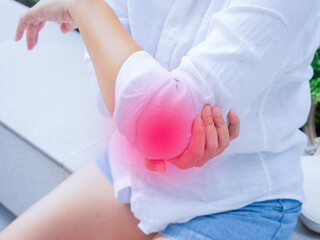 Asian woman and injury with elbow, pain and muscle strain while working. Female, lady with emergency for arm, inflammation and broken bone while on the park.