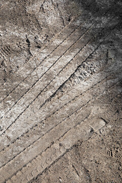 Close up of pattern texture of tyre tread tracks off road in sandy dirt