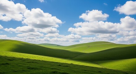 Rolling green hills under a blue sky with puffy clouds peaceful landscape photography