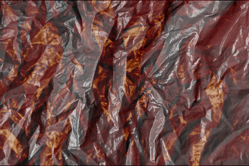 Abstract crumpled translucent plastic with fire texture on wrinkled foil background