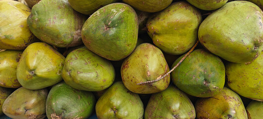 A pile of fresh green coconut.