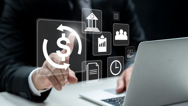 Businessman using a laptop while touching a currency icon. Technology innovation on a virtual screen. Concept of payroll