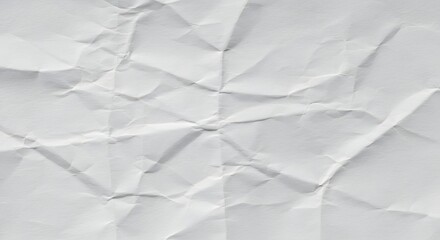 Fototapeta premium Crumpled white paper texture as a background image, ideal for presentation backgrounds, website banners, or creative typography posters with copy space.