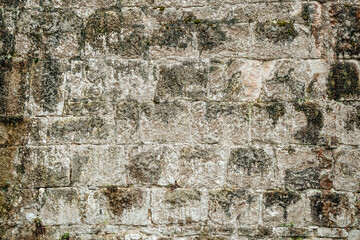 Antique ancient stone wall masonry texture background. Old wall made of beige stone blocks 