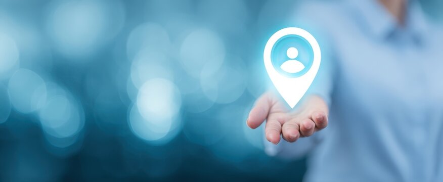 The hand presenting a digital location pin symbolizing connectivity and user engagement. - Powered by Adobe