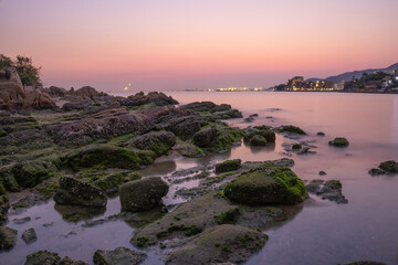 Beautiful sunset at a beach in Tuen Mun, New Territories, Hong Kong. Long exposure. Copy space
