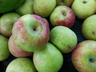 Piles of Fresh Local Green Apples in Supermarket Fruit Display.