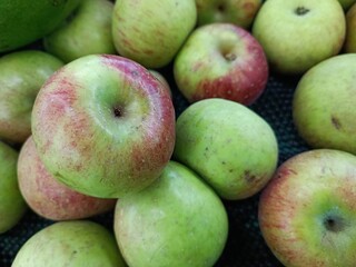 Piles of Fresh Local Green Apples in Supermarket Fruit Display.
