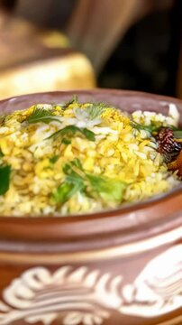 Bangladeshi panta bhat, a traditional fermented rice dish served in a rustic clay pot, flavored with mustard oil and spices. This ethnic comfort food showcases the unique flavors