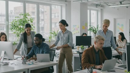 Collaboration in Modern Workplace: A diverse team of professionals engage in collaborative work within a modern office environment, fostering teamwork and innovation.  - Powered by Adobe