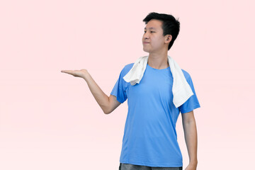 man in blue shirt wearing sports outfit holding out hand with pink background