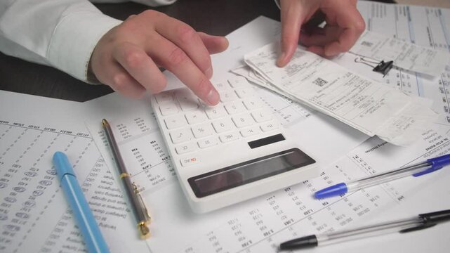 White calculator calculating household expenses checking receipts