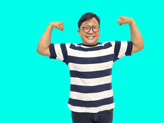 A joyful Asian man with glasses flexing his biceps, perfect for conveying strength, confidence,...