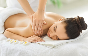 Professional shuolder massage treatment with aromatherapy, massage therapist doing oils massage, woman enjoying relaxing aromas spa, natural aromatics pleasure, soothing body and emotional balance