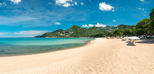 Beach Paradise,serene and beautiful beachscape of Thailand, showcasing the turquoise sea stretching to the horizon against fine white sand and a clear sky
