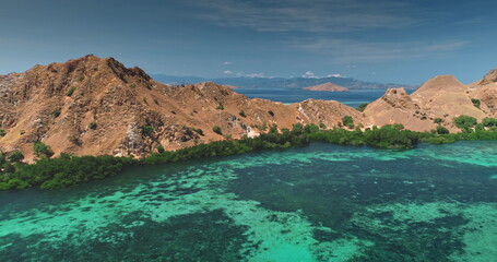Breathtaking aerial view of Komodo National Park in Indonesia, revealing turquoise waters caressing lush, picturesque islands in a mesmerizing tropical paradise