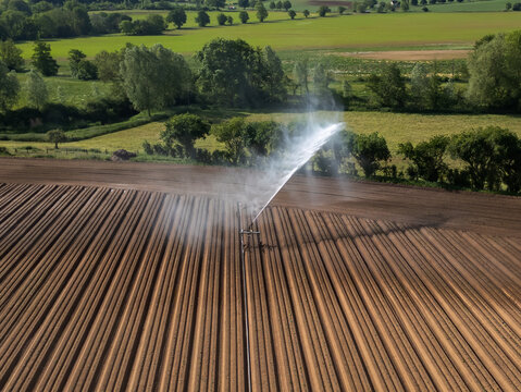 An aerial view of farmland being irrigated near Bures in Suffolk, UK