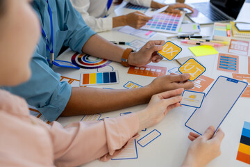 ux, ui, web and mobile app designers are discussing the look and feel of the website or app they...