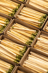 wooden matches with head in matchbox, the green head of a wooden match laid out in cardboard boxes,...