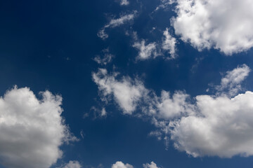 Fototapeta premium beautiful sky with clouds in sunny bright weather, natural blue sky with cumulus clouds illuminated by sunlight