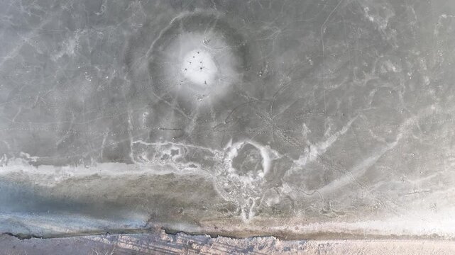 Frozen lake in the morning fog on a sunny day aerial shot from a drone. Pogoria lake in winter, Dabrowa Gornicza, Poland. Ice shrouded lake in fog.