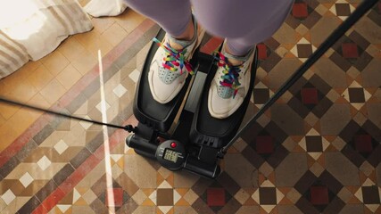 Woman doing exercises on stepper at home, Close up of legs with sneakers. High quality 4k footage - Powered by Adobe