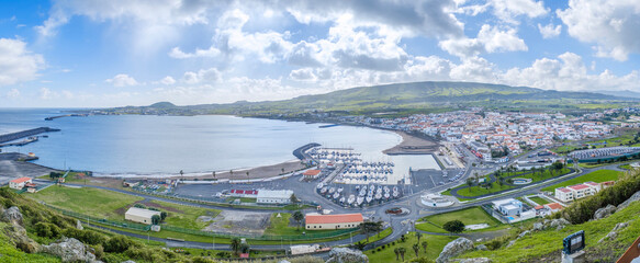 Panoramic View of Praia da Vitoria Bay and Coastal Town in Terceira, Azores. Portuguese harbor, Atlantic island, scenic landscape, vibrant community, tourism destination © ikuday