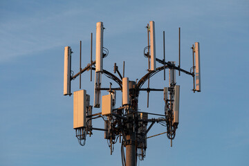 High-resolution close-up of a modern cell tower with multiple antennas and transmission equipment. Showing advanced wireless communication and mobile network infrastructure in the USA