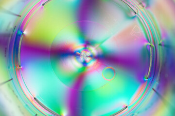 Vivid colors refract through translucent plastic in an abstract circular pattern