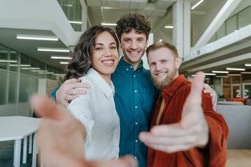 Business team smiling and embracing in an office setting