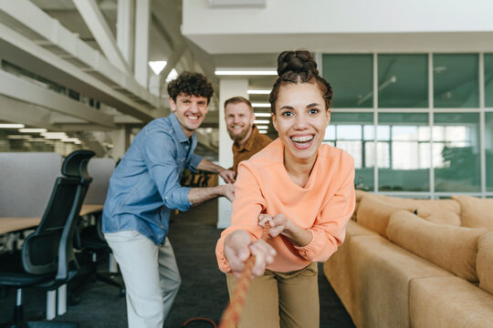 Ambitious business people participating in tug-of-war contest