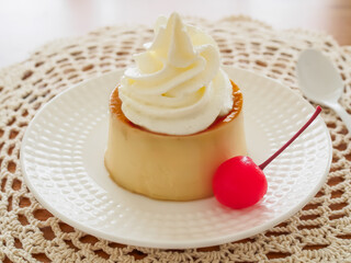 クリームとサクランボを添えた手作りのプリン