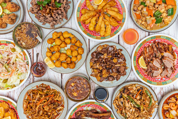 A table full of dishes of Chinese food typical of Western restaurants