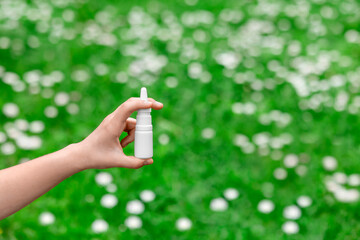 Allergy Nasal Spray on Spring Flower Background. Seasonal Allergies Nose Spray in Child Hand on...