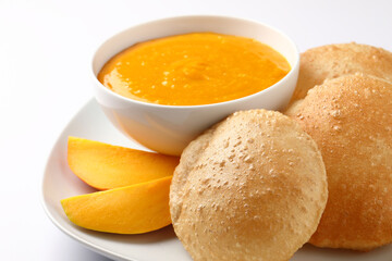 Aam ras served with puri and slice of mango. Delicious Indian Snack 