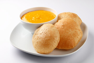 Aam ras served with puri and slice of mango. Delicious Indian Snack 
