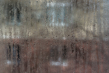 Slow-growing condensation droplets pattern interior glass like morning dew. abstract with glass...