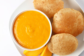 Aam ras served with puri and slice of mango. Delicious Indian Snack 