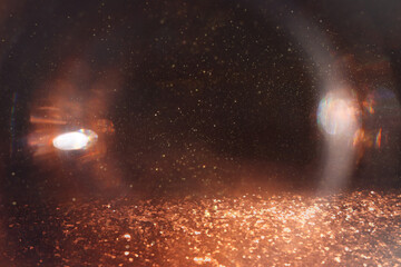 abstract glitter gold and black lights background. de-focused
