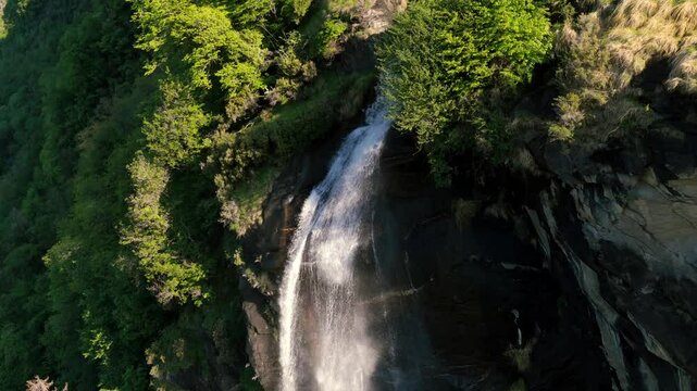 Close up aerial of water cascading from top of Acquafraggia falls, Italy
