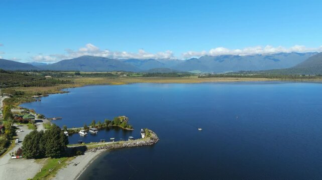 Panoramic view over Lake Brunner with the Southern Alps of New Zealand in the background.
