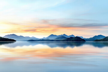 Obraz premium Tranquil lake with pastel reflections and serene mountains in background creates peaceful atmosphere