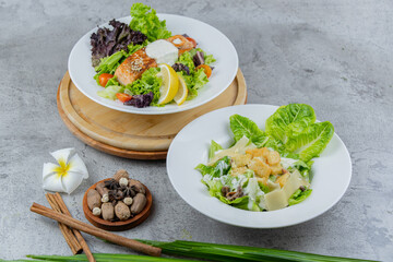 Healthy salmon salad with mixed greens, grilled salmon, cherry tomatoes, and lemon. A light and fresh dish perfect for healthy eating and food photography.